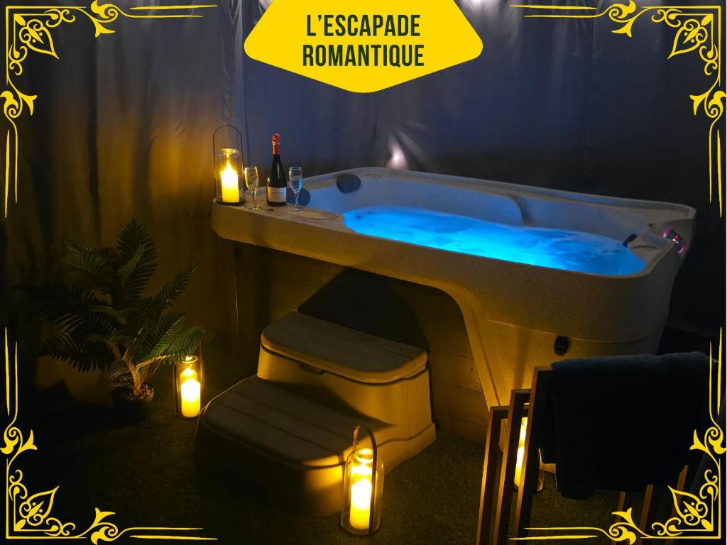 a bathroom with a blue tub with candles and lights at Studio cosy - Jacuzzi inclus - À 5 min du Mans in Mulsanne