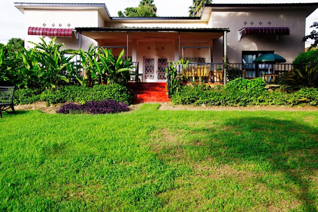a house with a green lawn in front of it at Spa Elpis in Kigali