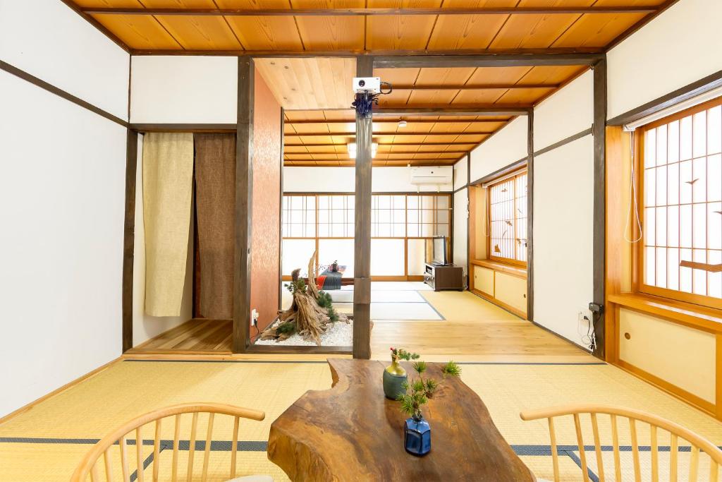 a large room with a wooden table and chairs at Goen in Iwaki
