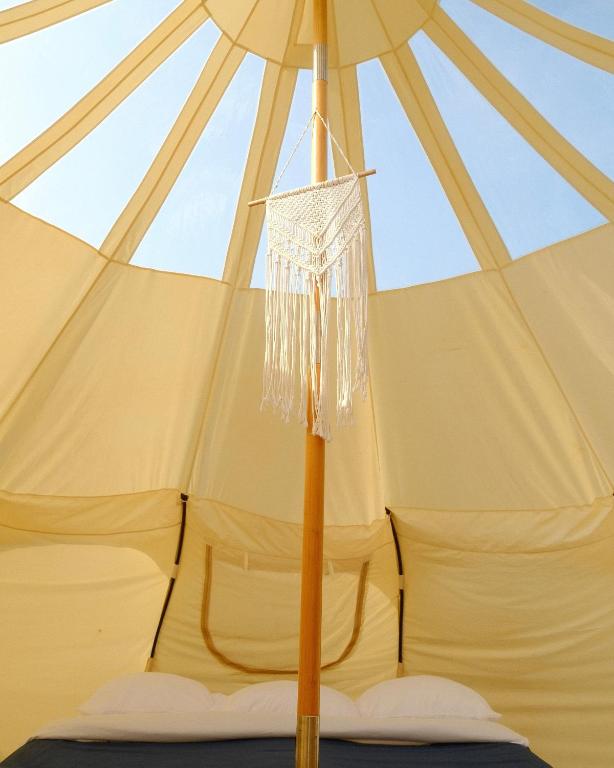 a tent with a chandelier hanging from it at Hôtel UNIQ - Domaine Saint-Bernard - Tentes Glamping in Mont-Tremblant