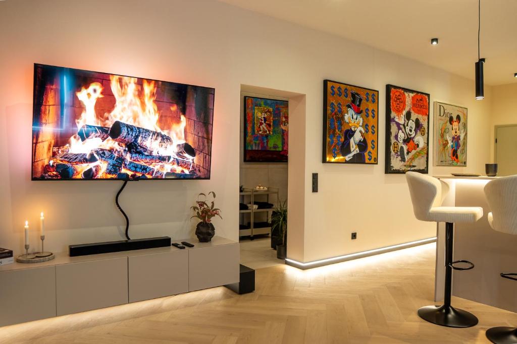 a living room with a tv hanging on a wall at ART&SPA Koblenz in Koblenz