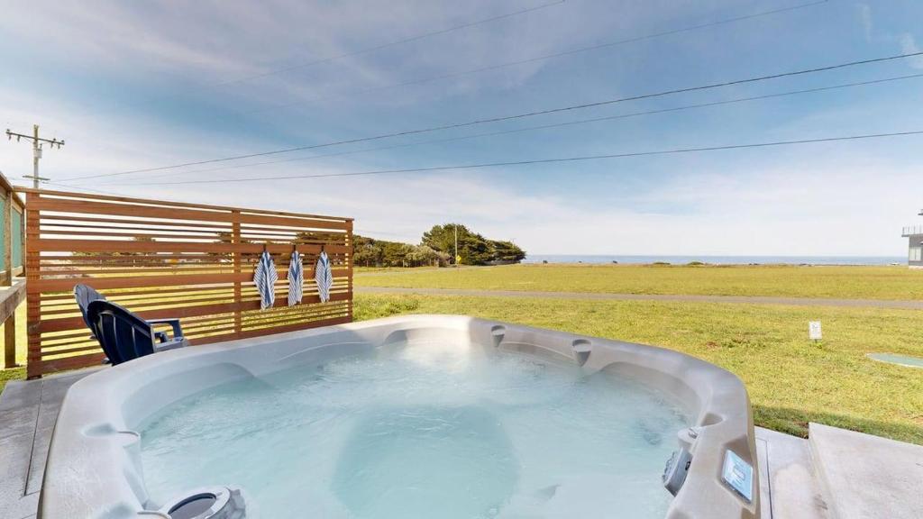 a hot tub with a view of a field at Dog Friendly Oceanfront Home with Hot Tub & Views in Fort Bragg