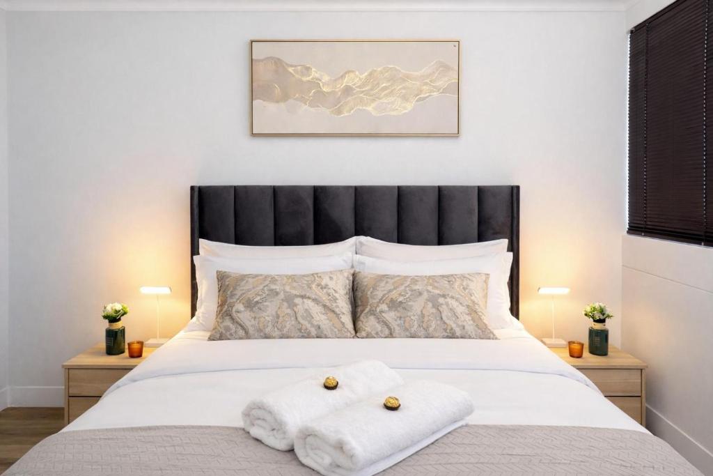 a bedroom with a bed with two towels on it at Jubilee Stay in Windhoek