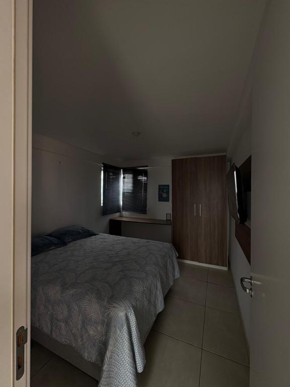 a bedroom with a bed and a window and a television at Studio One 1107 in Juazeiro do Norte