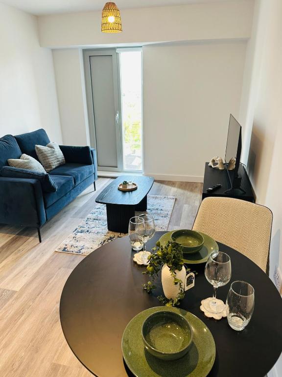a living room with a table and a couch at Stylish Modern 1-Bed Apartment in Manchester