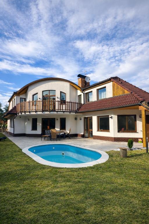 a large house with a swimming pool in the yard at Villa Grande Praha in Prague
