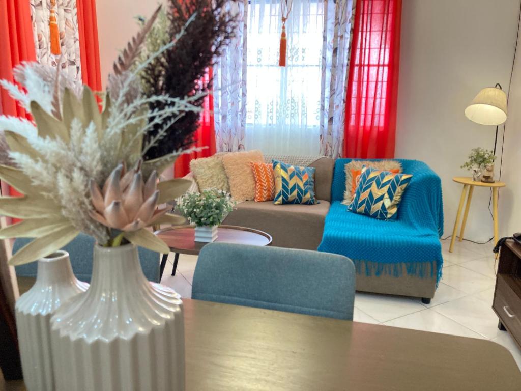a living room with a couch and a table at Bahay-Kapehan sa Villa in Tambo