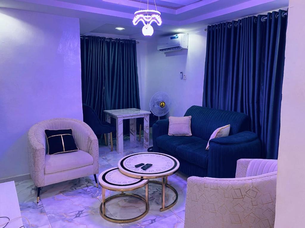 a living room with a couch and chairs and a table at Luxury and premium one bed in Ikeja