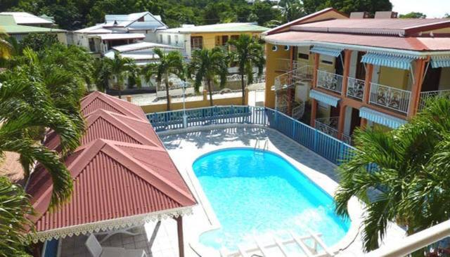 an overhead view of a swimming pool in a building at La Pointe d'Argent in Pointe-Noire