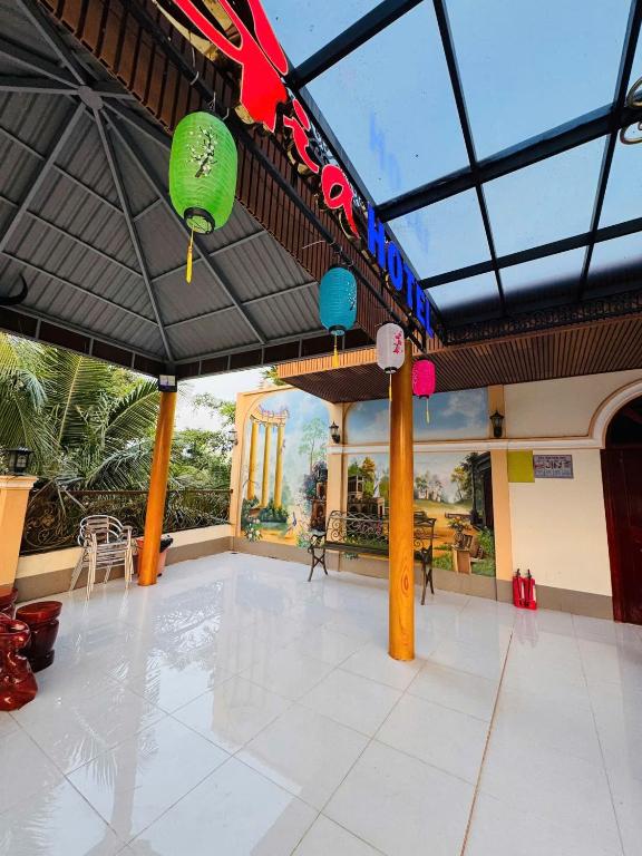a large room with an umbrella in a building at Lê Gia HOUSE KG in Kiên Lương