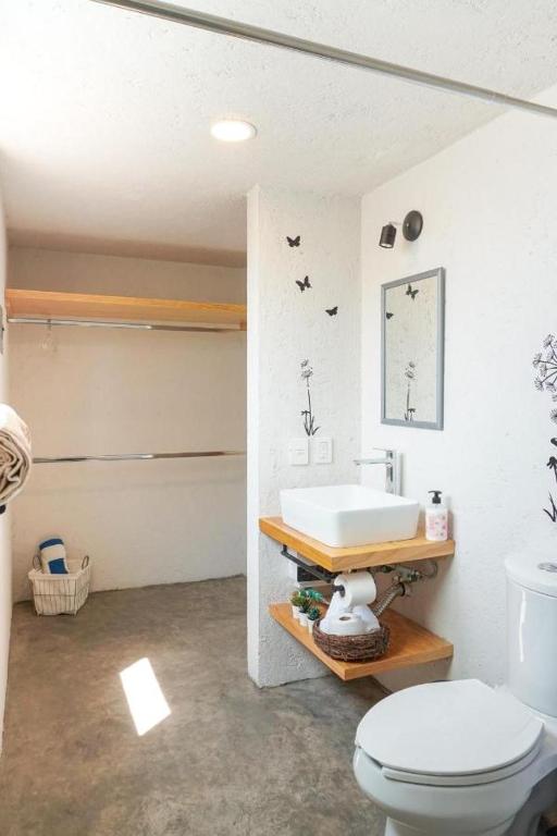 a bathroom with a white sink and a toilet at Portal M Chalets in Chalma