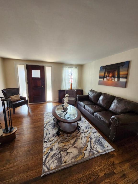 a living room with a leather couch and a coffee table at Lansdowne Gem in Lansdowne