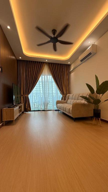 a living room with a couch and a ceiling fan at SeFA Cozy Stay in Malacca