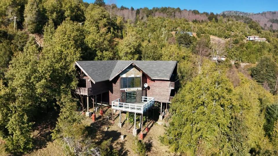 an aerial view of a house in the woods at casa caburgua en cerro in Caburgua