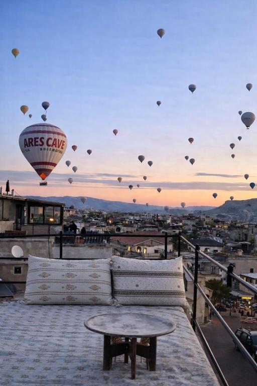 a group of kites flying in the sky over a city at Ares Cave Suites in Göreme