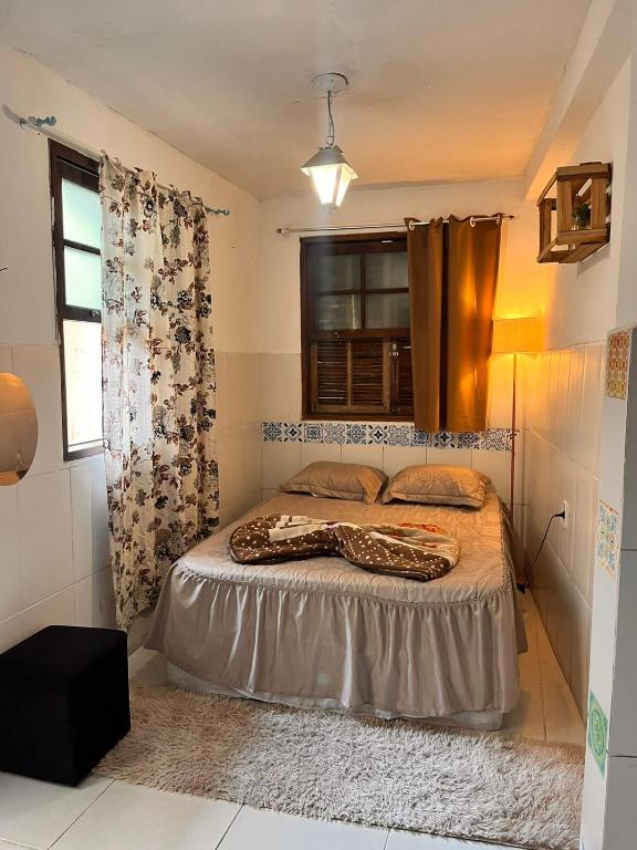 a bedroom with a bed and a window at Uai hostel in Ouro Preto