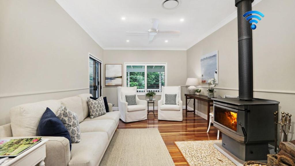 a living room with a couch and a fireplace at Somerset in Robertson