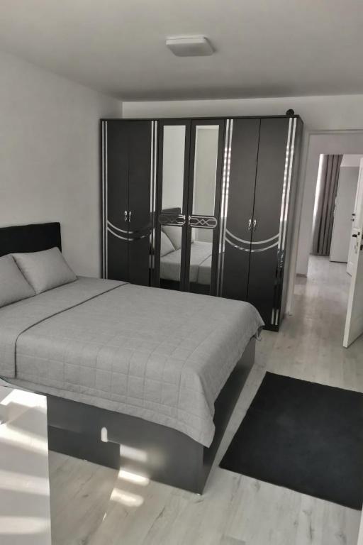 a bedroom with a bed and a black cabinet at Casa Lucy in Alexandria