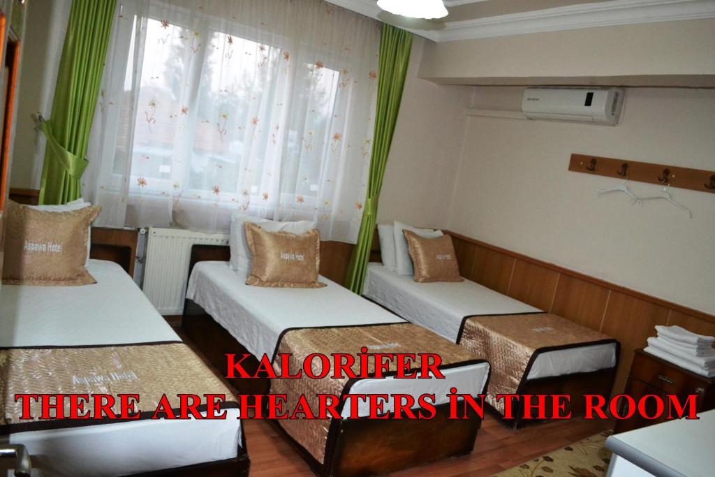 A bed or beds in a room at Aspawa Hotel
