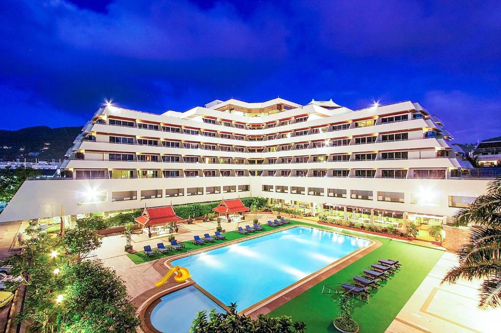 a large hotel with a swimming pool in front of it at Patong Resort Hotel - SHA Extra Plus in Patong Beach