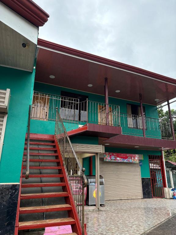 a building with a staircase in front of it at Hospedaje Alejandra in Canoas