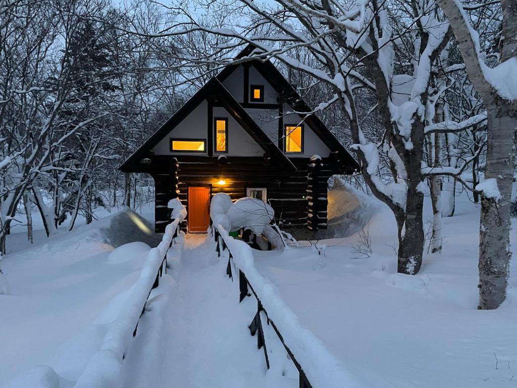 a cabin in the woods in the snow at Appi Ski Chalet in Hachimantai