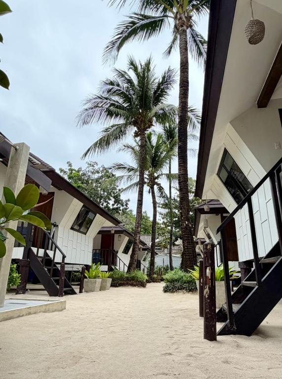 a building with palm trees in front of it at Casitas de Boracay in Boracay