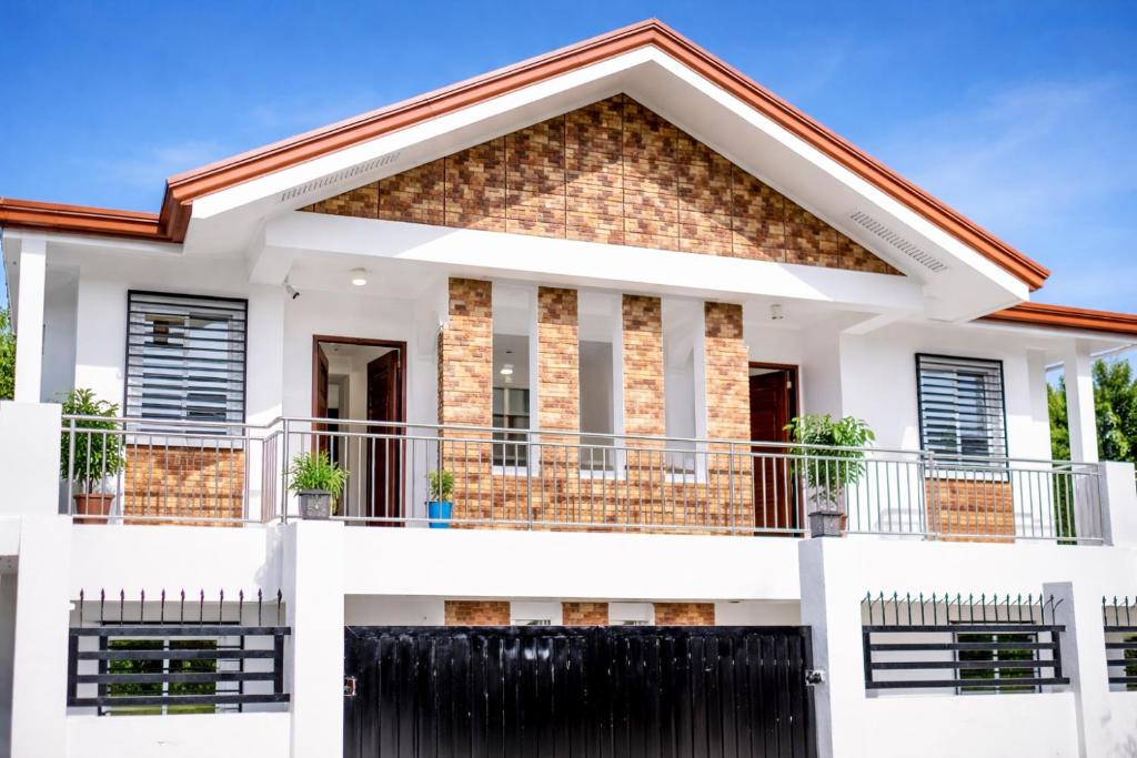 a house with a fence in front of it at Jannish Transient House in Masbate