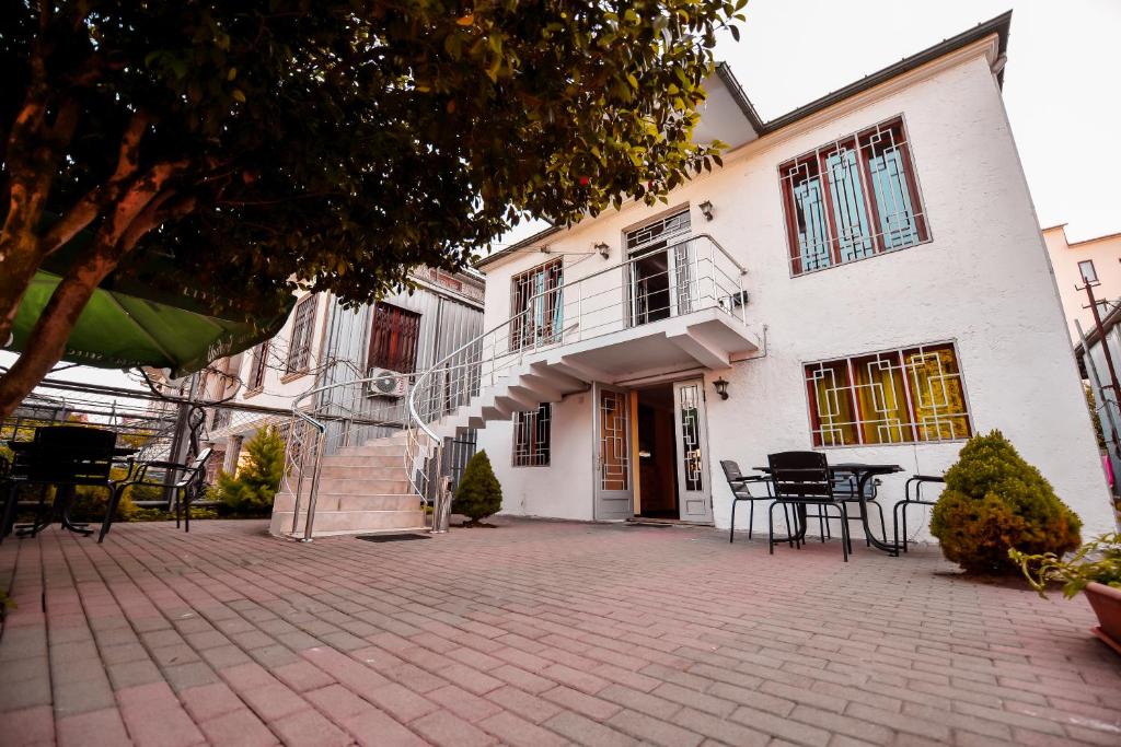 a building with tables and chairs in front of it at Casa Camellia in Kobuleti