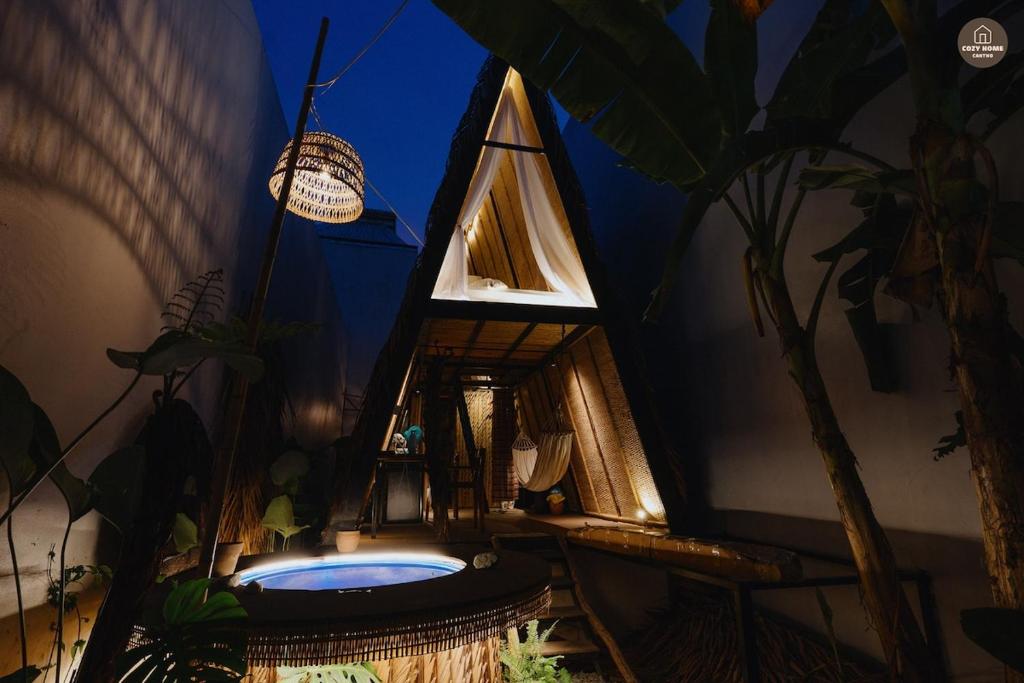 a small house with a bath tub in a room at mango house, hide out Can Tho in Ấp Bình Thương