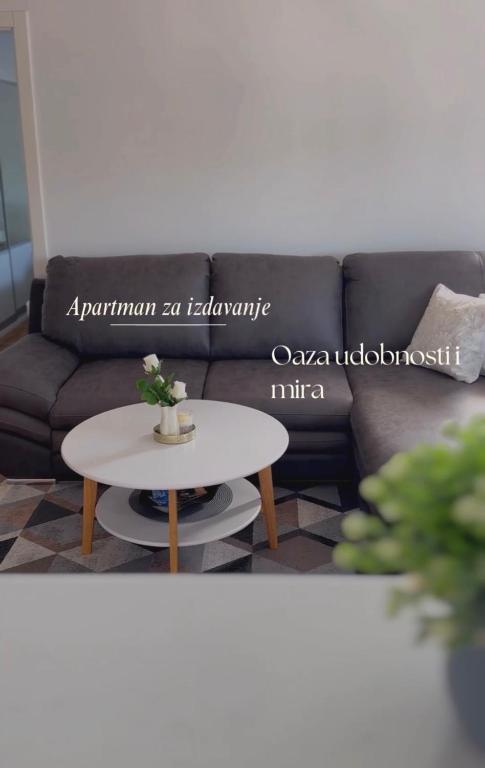 a black couch with a white table in a living room at Sunset in Teslić