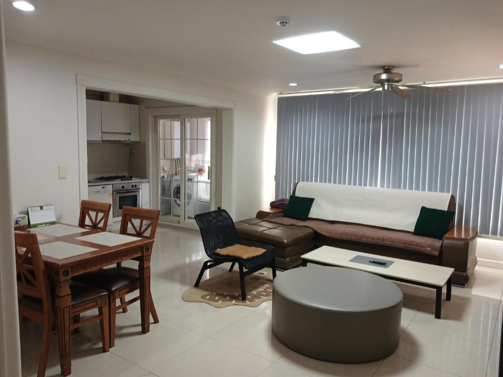 a living room with a couch and a table at Park Vill 202 in Pyeongtaek