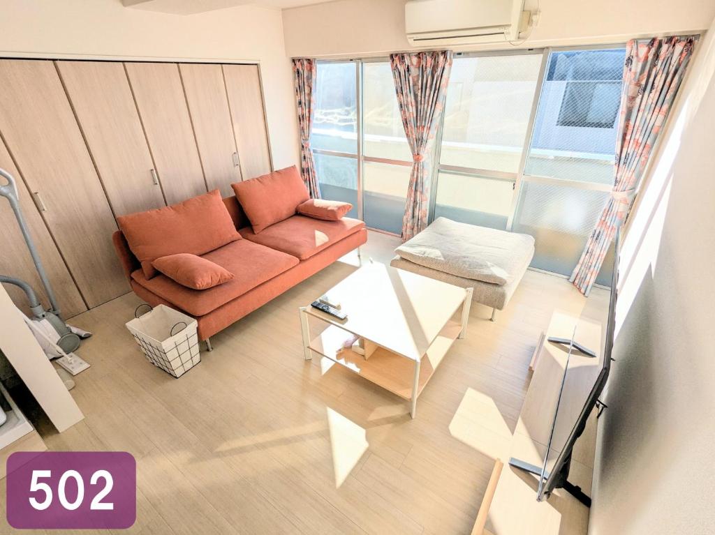 a living room with a couch and a table at Chateau Sunrise in Tokyo
