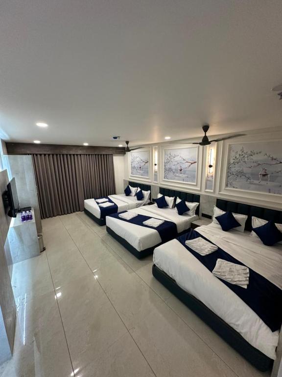 a room with four beds in a room with at Hotel Crown in Dwarka