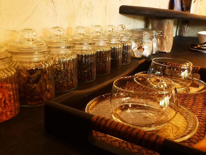 a bunch of glass jars sitting on a table at Taketomijima Akaneya in Taketomi