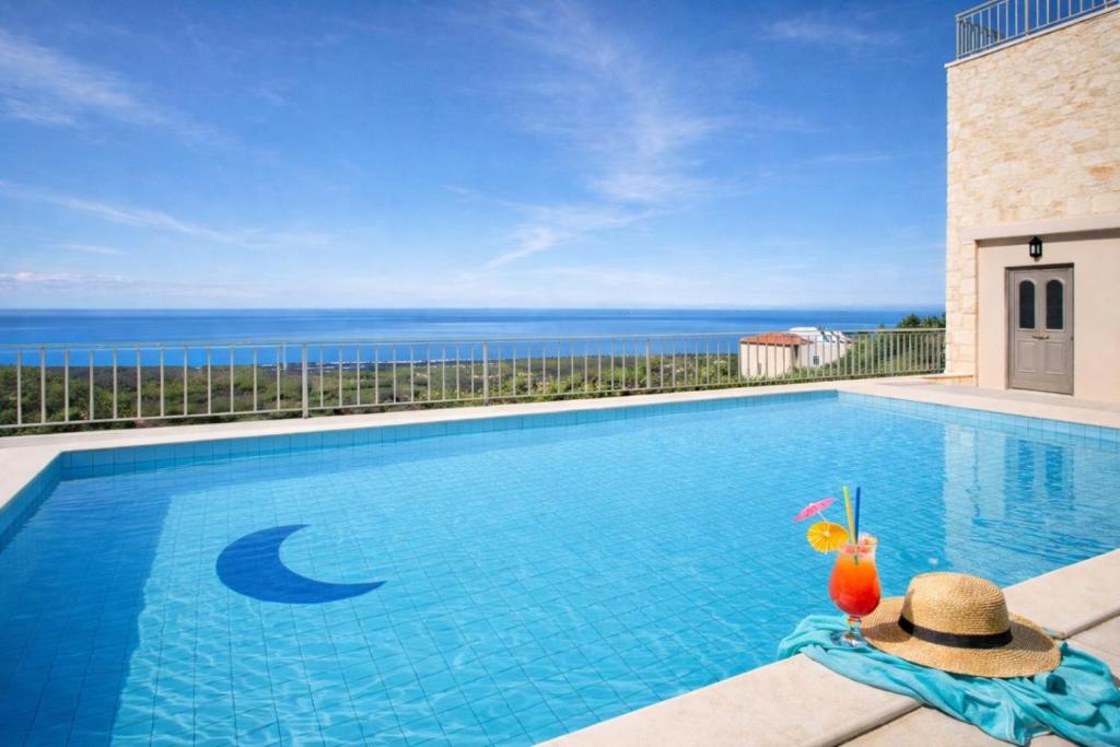 a swimming pool with a view of the ocean at Great Escape Sea View Private Pools, Jacuzzi & Ultimate Relaxation in Maroulás
