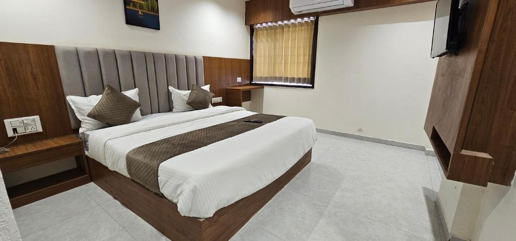 a bedroom with a large bed in a room at Hotel Glory in Bavla