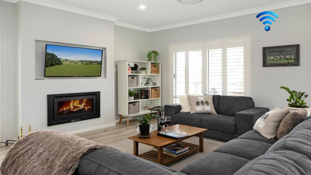 a living room with a couch and a fireplace at The Bunkhouse in Exeter