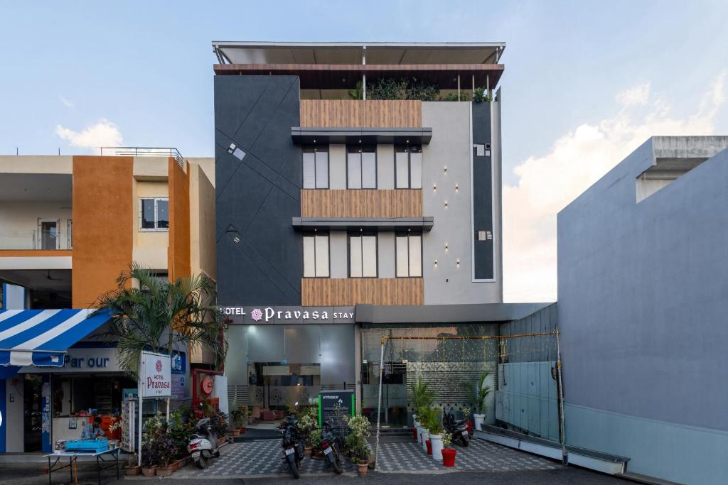 a building with a plant on the top of it at Hotel Pravasa Stay, Dewas Naka in Indore