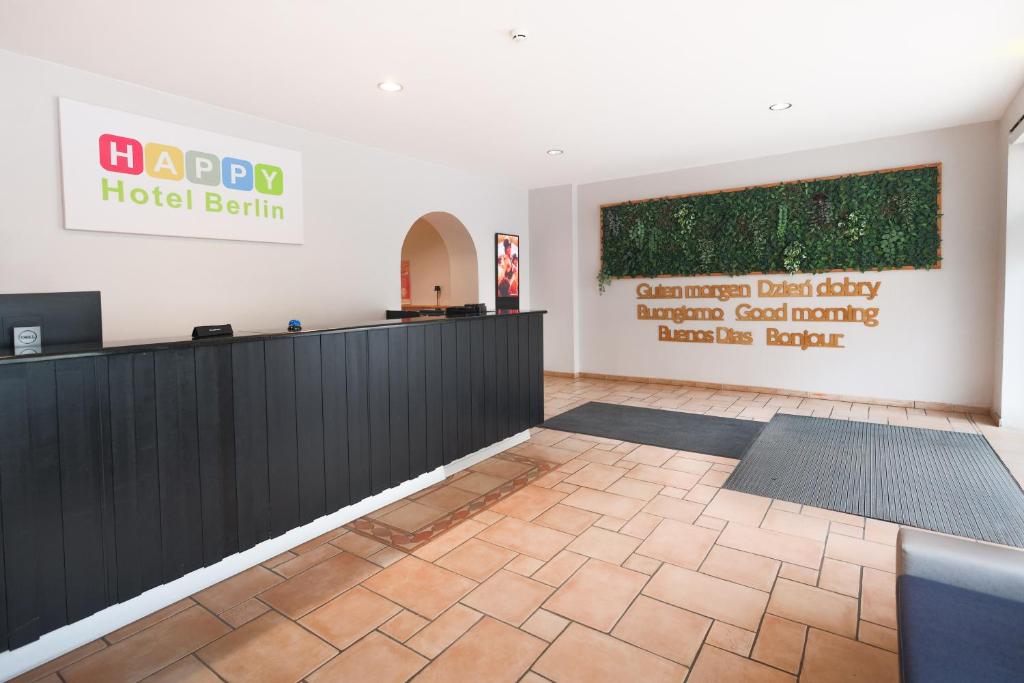 a lobby of a hotel berlin with a sign on the wall at Happy Hotel Berlin in Berlin