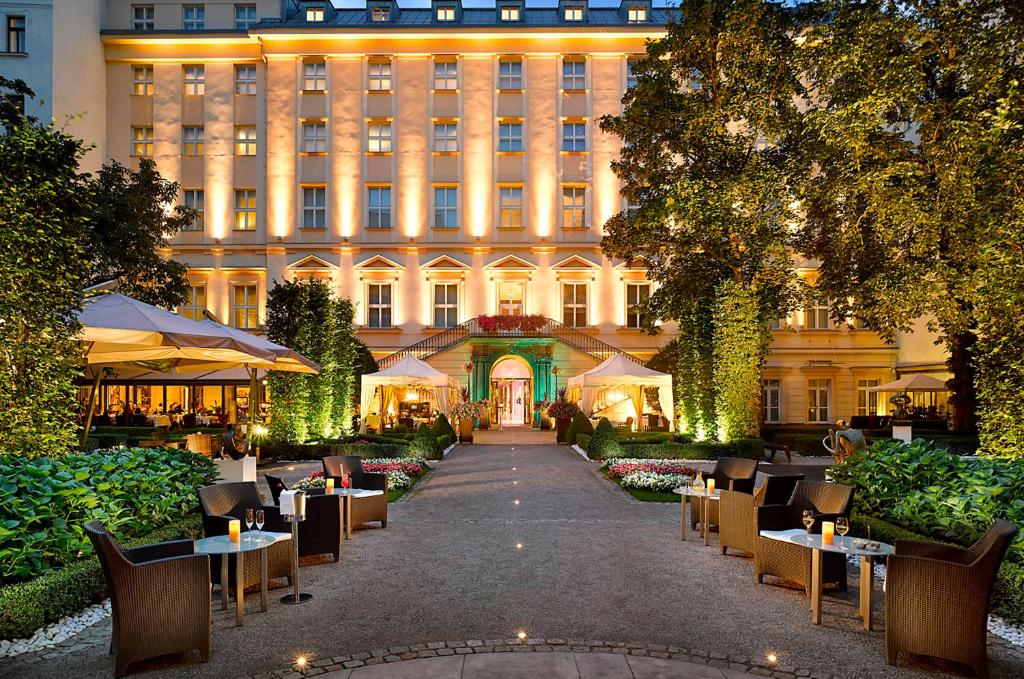 un hotel con mesas y sillas frente a un edificio en The Grand Mark Prague - The Leading Hotels of the World en Praga