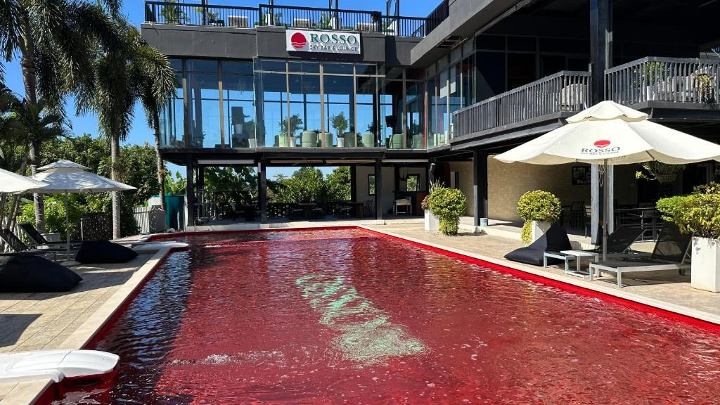 a red pool in front of a building at Rosso Sky Villa Phu Quoc in Phú Quốc