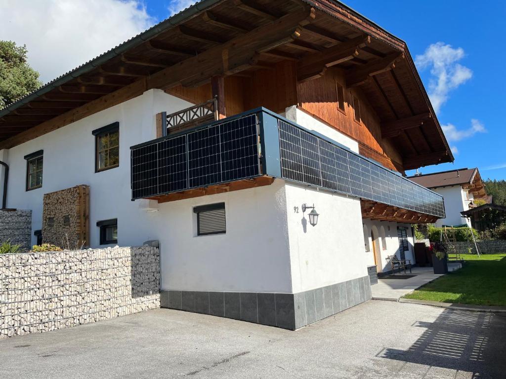 a building with solar panels on top of it at Ferienwohnung Schmiedhofer in Ellmau