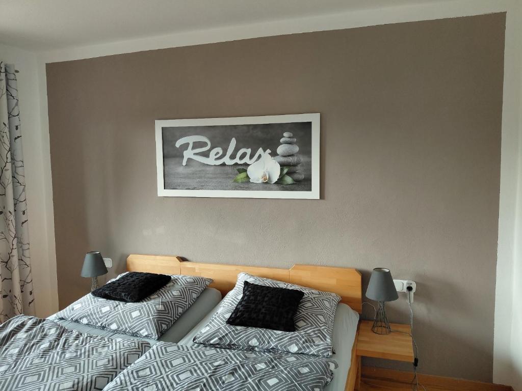 a bedroom with two beds and a picture on the wall at Ferienwohnung Lorke in Thiersheim