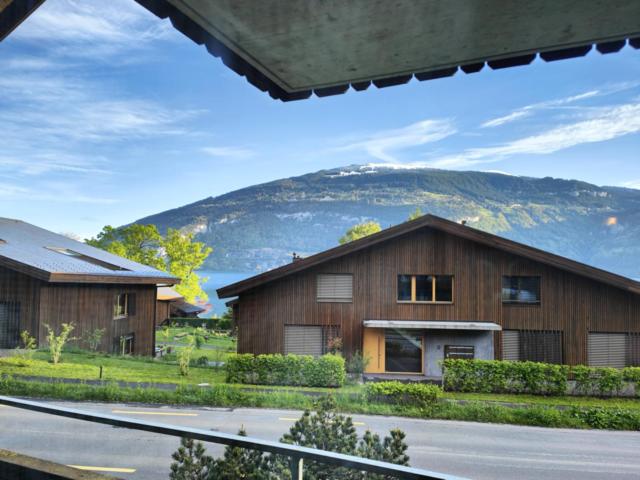 a large house with a mountain in the background at Leissi2025 in Leissigen