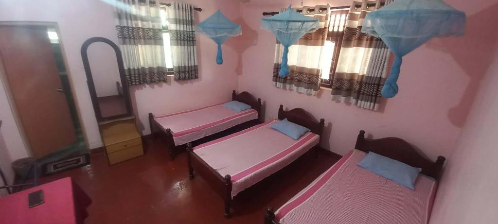 an overhead view of two beds in a room at New Olina Gest and Restaurant in Wellawaya