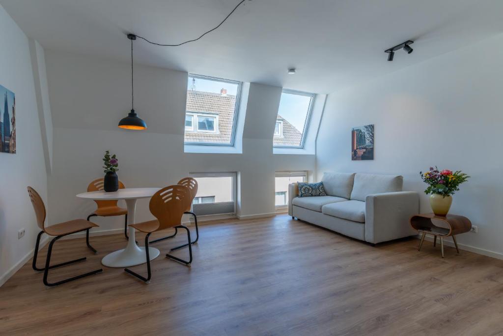 a living room with a couch and a table at Jotica Colonia in Cologne