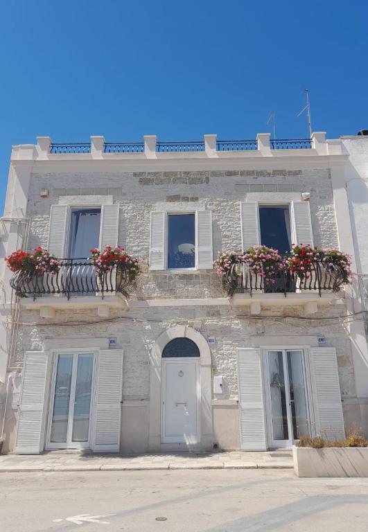 a building with flowers on the balconies and a door at Marè Sunrise in Bari