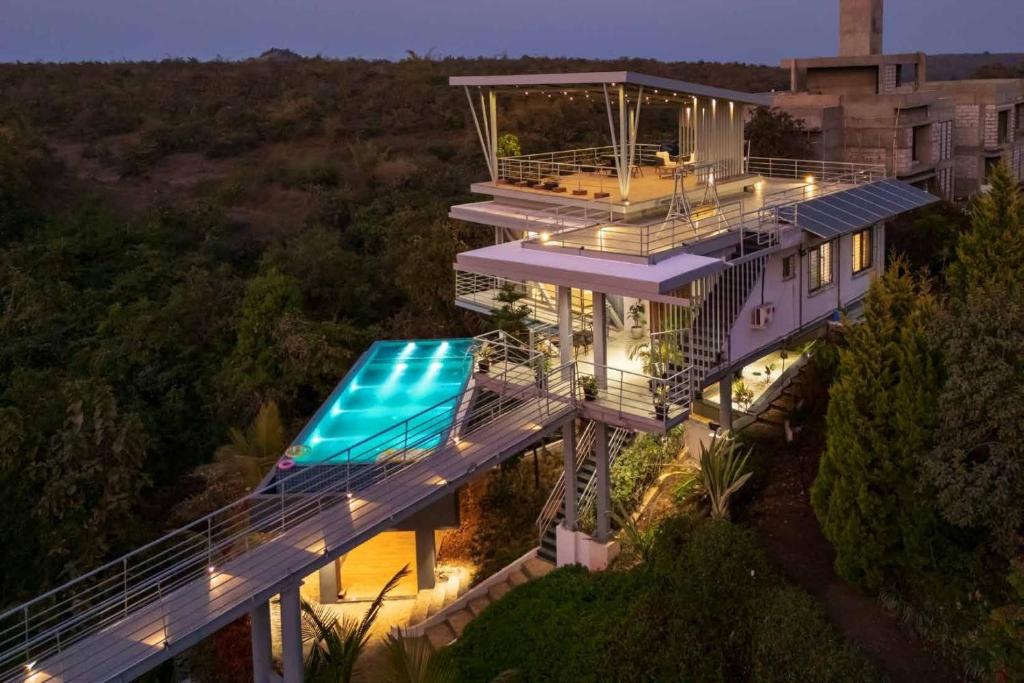 an aerial view of a house with a swimming pool at Grape County Eco Resort & Spa, Nashik in Nashik