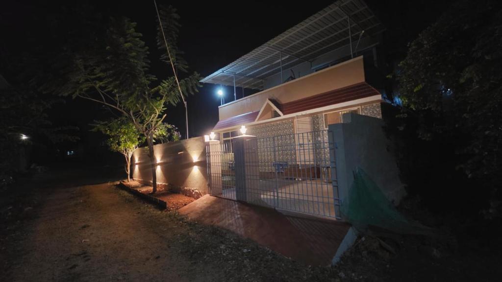 a building with a fence in front of it at night at June Villa Feel at Home at yelagiri hills in Yelagiri